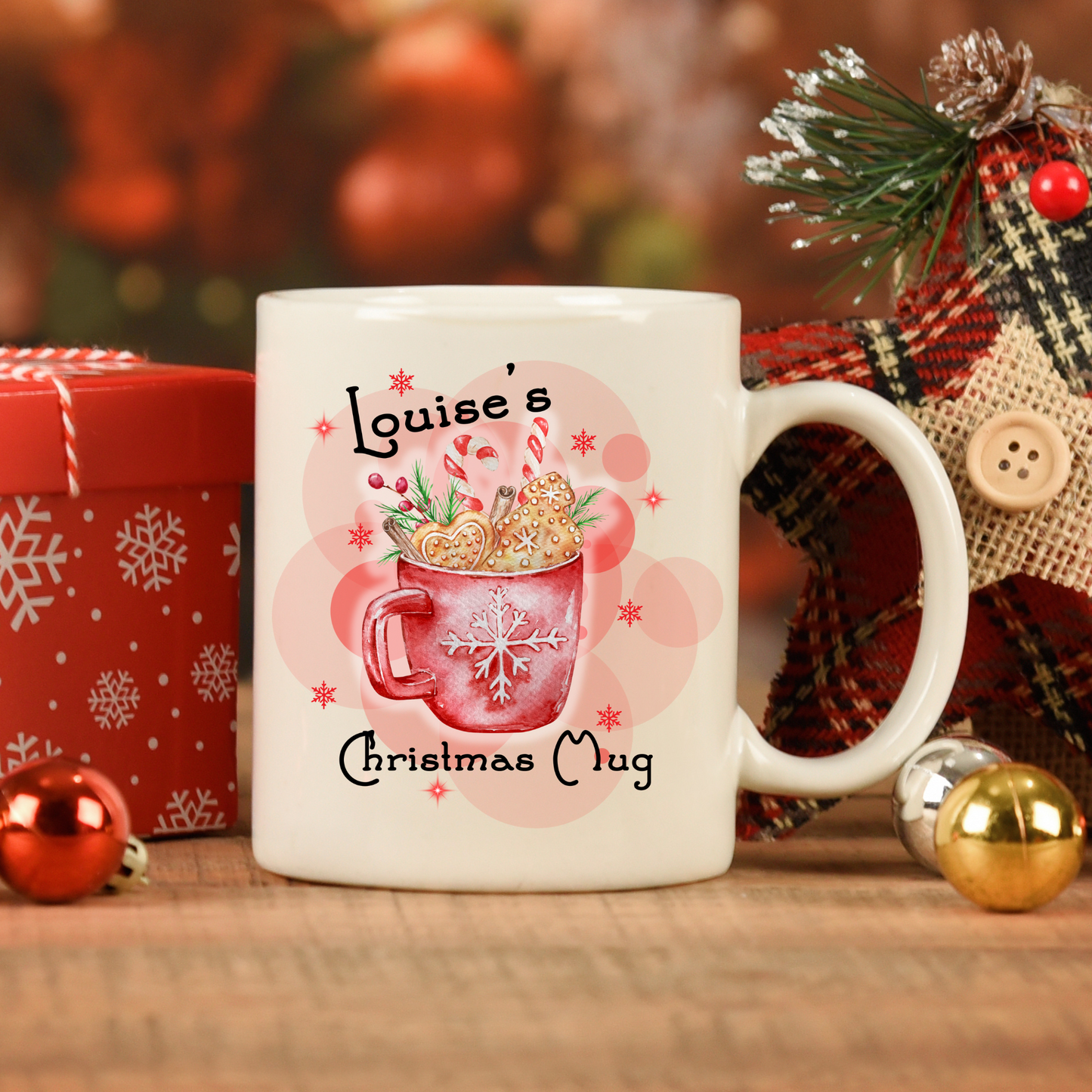 Christmas mug with personalised name, showcasing a cozy winter scene with a steaming mug filled with gingerbread cookies, candy canes, and cinnamon sticks.